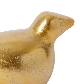 Gold bird-shaped decorative object on a white background