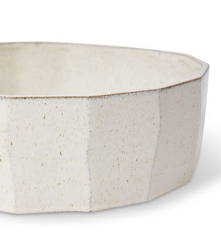 White ceramic bowl with a textured surface on a white background