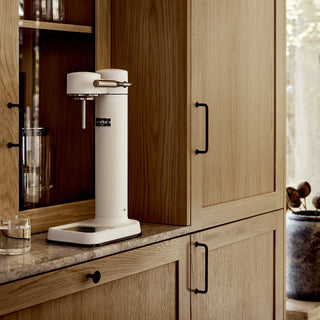 White coffee machine on a wooden kitchen counter