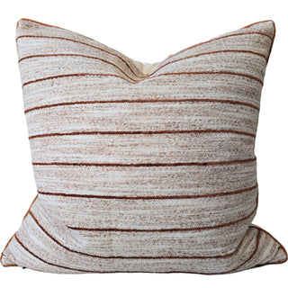 Striped pillow with brown and beige pattern on a white background