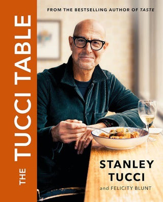 Book cover of 'The Tucci Table' featuring a man at a table with a bowl of food and a glass of wine.