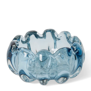 Blue glass bowl with wavy design on a white background