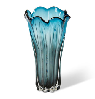 Blue glass vase with wavy design on a white background