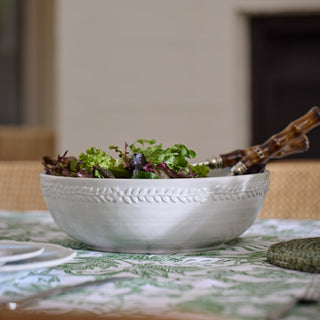 White bowl with salad on a patterned tablecloth