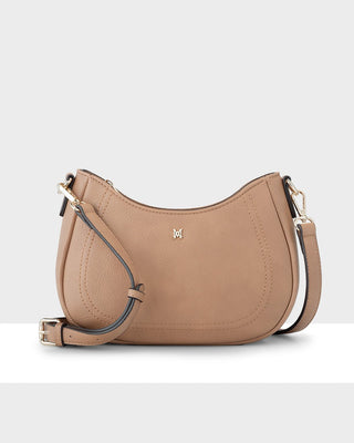Tan handbag with a visible brand logo on a light gray background