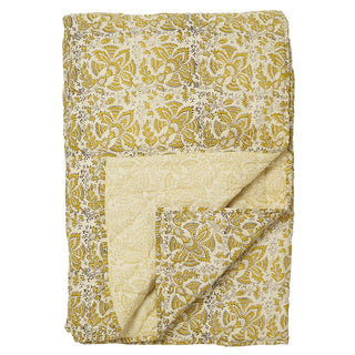 Clovelly Golden Quilt - Folded fabric with mustard and white floral pattern on a white background