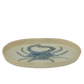 Round ceramic plate with a blue crab design on a white background