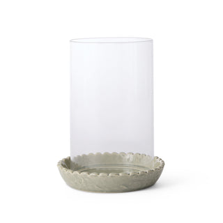 Clear glass with decorative green base on a white background