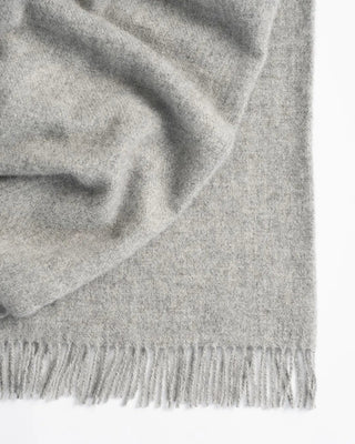 Gray scarf with fringes on a white background