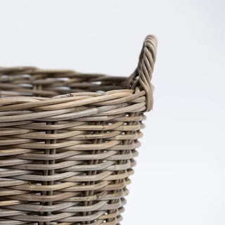 Woven basket with a handle on a white background