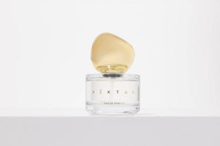 Perfume bottle labeled 'Nektar' on a light gray background