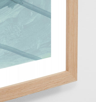 Close-up of a wooden frame with glass panel on a white background