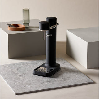 Black kitchen appliance on a gray surface with a neutral background