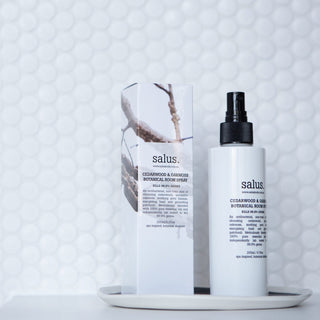 Salus room spray bottle and packaging on a textured white background