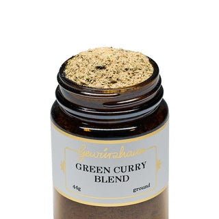 Jar of green curry blend with a visible brand name on a white background