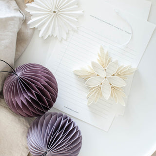 Decorative paper flowers and balls on a light surface