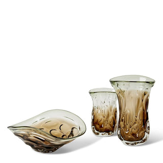 Set of three brown glass vessels on a white background