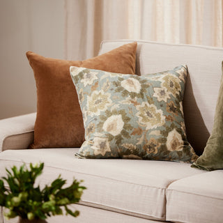 Decorative pillows on a sofa with a neutral background