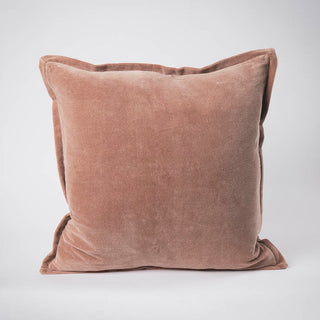 Brown velvet pillow on a light gray background