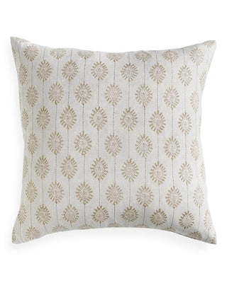 Decorative pillow with gold floral pattern on a white background