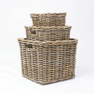 Set of three woven baskets on a white background