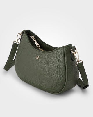Green handbag with a gold zipper and brand logo on a light gray background