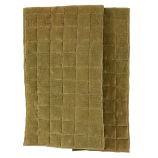 Folded green quilt on a white background
