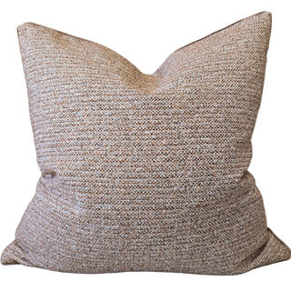 Textured pillow with a neutral color scheme on a white background