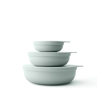 Set of three light gray bowls stacked on a white background