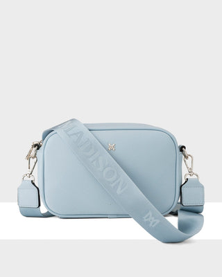 Light blue handbag with a strap on a white background