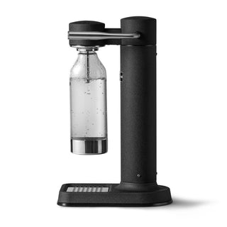 Black carbonation machine with a clear bottle filled with carbonated water on a white background