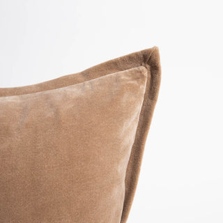 Close-up of a brown velvet pillow on a white background