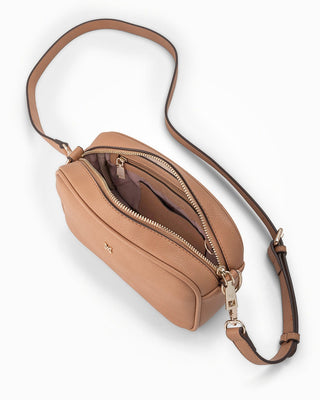 Tan crossbody bag with a strap on a white background