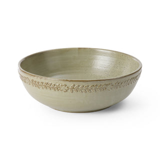 Green ceramic bowl with decorative rim on a white background