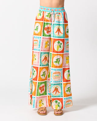 Colorful patterned pants with vintage label design on a white background