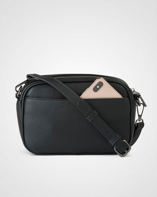 Black leather crossbody bag with a phone case on a light gray background