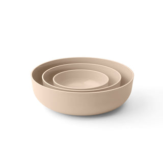 Set of three beige bowls of different sizes on a white background