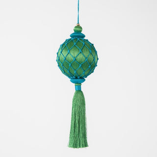 Decorative green ornament with tassel on a white background