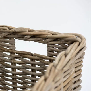 Close-up of a woven basket with a plain background