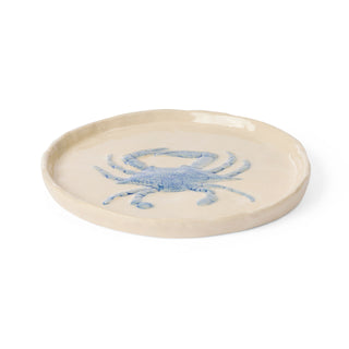 Ceramic plate with a blue crab design on a white background