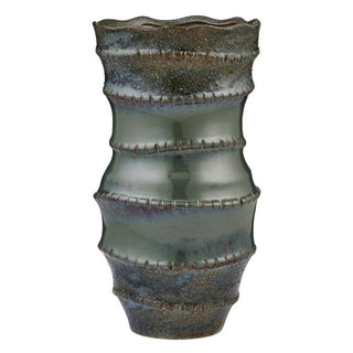 Ceramic vase with textured surface on a white background