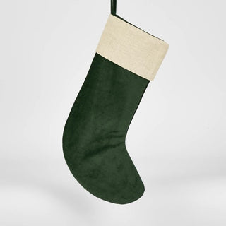 Green Christmas stocking with beige top on a white background