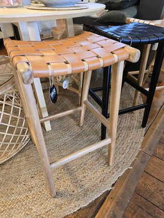 Woven stools on a wooden floor.