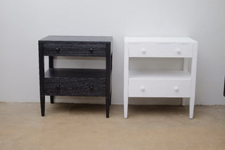Black and white nightstands against a plain wall.
