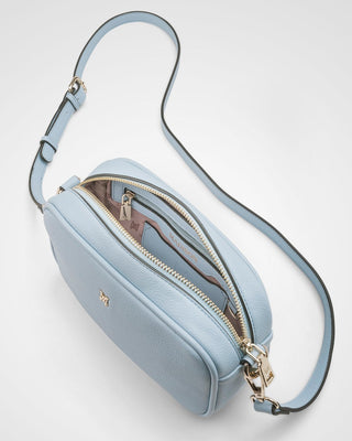 Light blue crossbody bag with a strap on a white background
