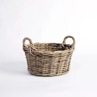 Wicker basket with handles on a white background