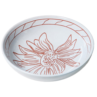 White ceramic bowl with red floral design on a white background