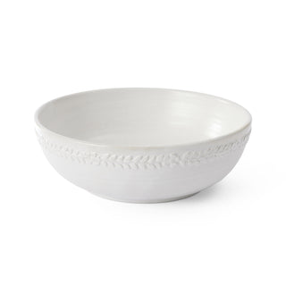 White ceramic bowl with textured rim on a white background