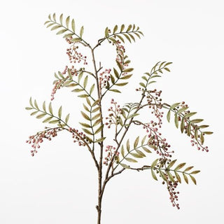 Artificial plant branch with green leaves and pink berries on a white background