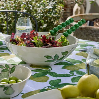 Bowl of salad on a table with a green leafy pattern